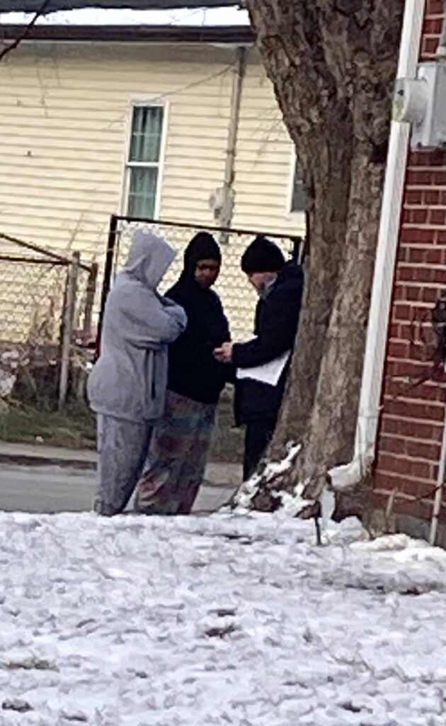 A soul winner sharing the Gospel with a woman at the last door of the day in Battle Ground, Washington. Led by the Holy Spirit, the evangelist explains the truth of salvation and the power of Jesus Christ.