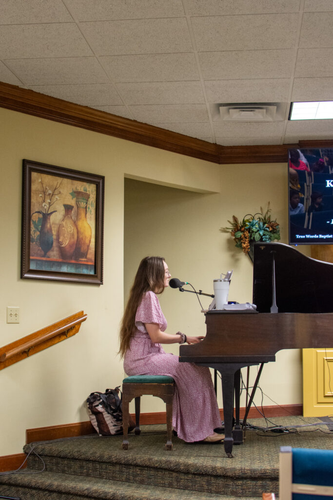 Congregation at True Words Baptist Church singing traditional hymns during worship service.