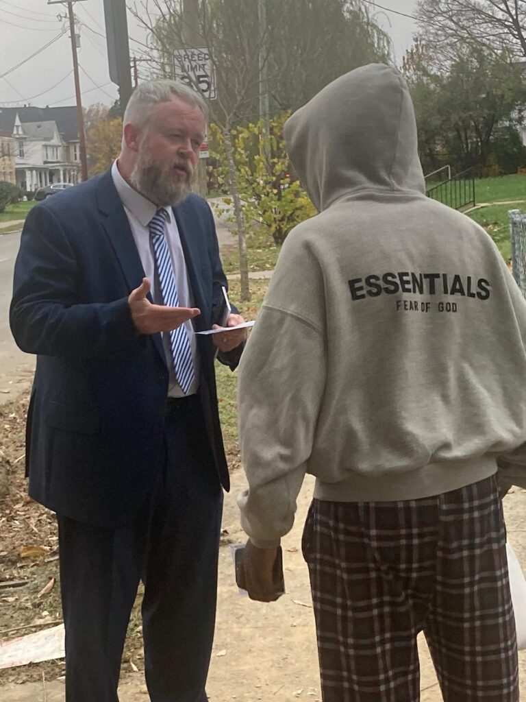 Joshua Tapp preaching the Gospel to a young man in West Louisville.