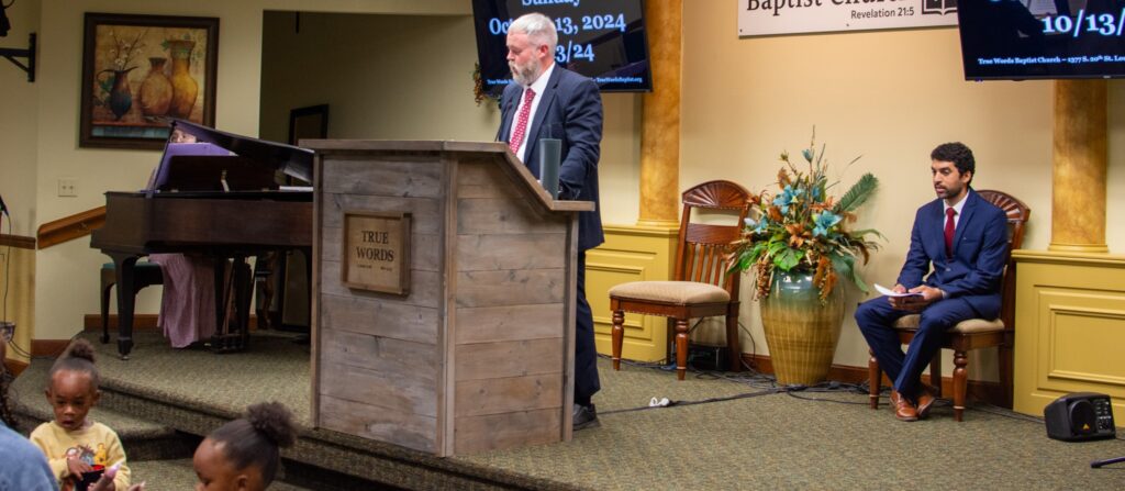 Pastor Joshua Tapp delivering a biblical sermon from the King James Bible at True Words Baptist Church.